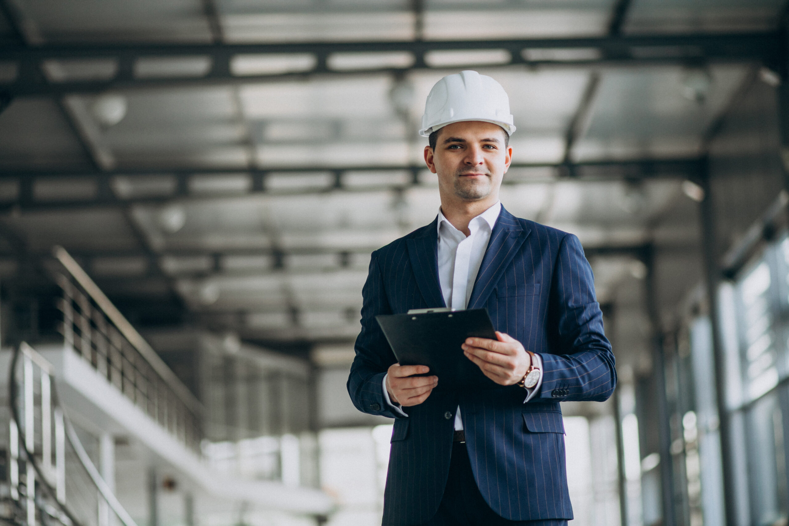 A construction project manager reviewing a dynamic project dashboard on a large screen.